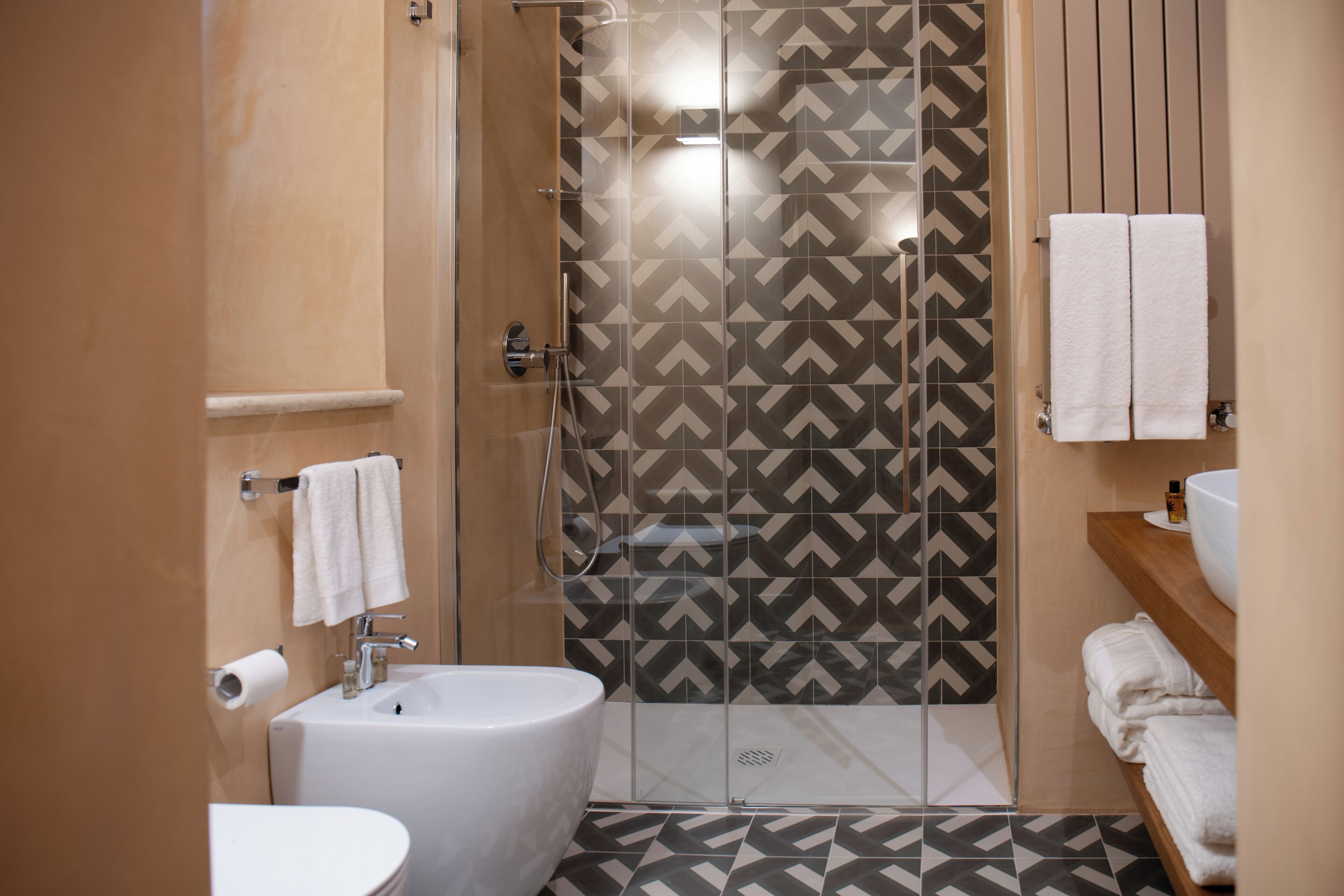 A bathroom with a bathtub, a shower, and a sink.
