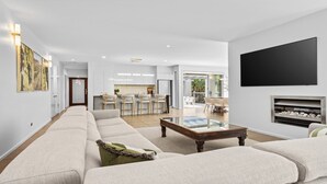 Ein modernes Wohnzimmer mit einer Couch, einem Couchtisch und einem Kamin.