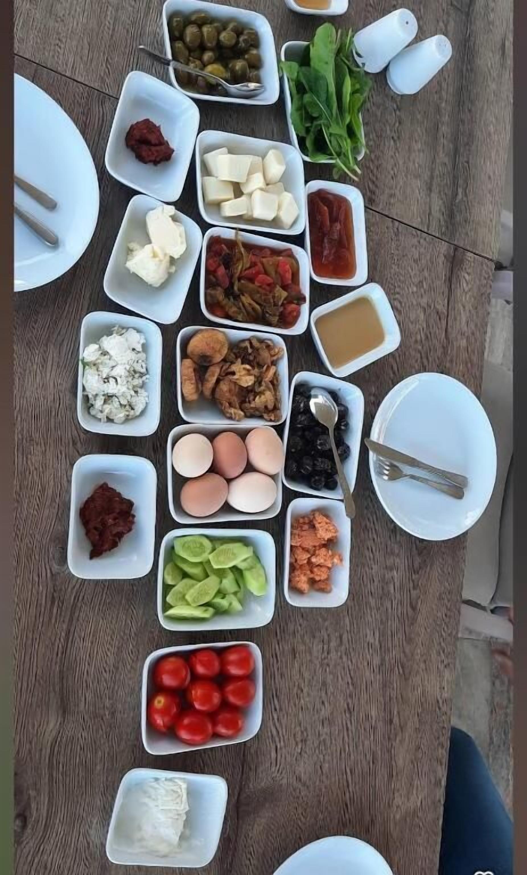 A table with various food items and utensils.
