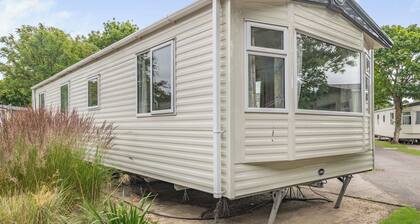 Gold Caravan. With parking and decking.