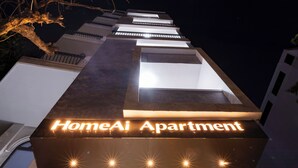 A building with a sign reading 'HomeAi Apartment' and a modern architectural design. - HomeAi Apartment - Binh Thanh near LM81 (Ho Chi Minh City)