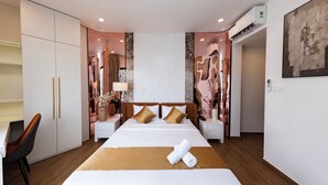 A hotel room with a bed, bedside tables, a wardrobe, and an air conditioning unit. - HomeAi Apartment - Binh Thanh near LM81 (Ho Chi Minh City)