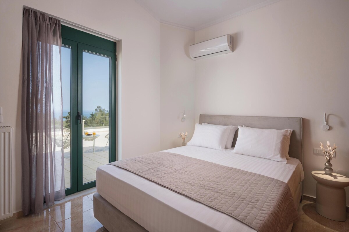 A bedroom with a bed, a sliding glass door to a balcony, an air conditioning unit, and a bedside table with a vase.