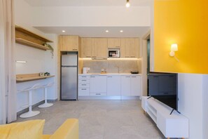 A modern kitchen with white cabinets, a built-in microwave, and a refrigerator. - DeMar No 5 by RentalsPro - Agios Nikolaos (Chalkidiki)