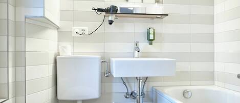 A bathroom with a toilet, sink, and bathtub.
