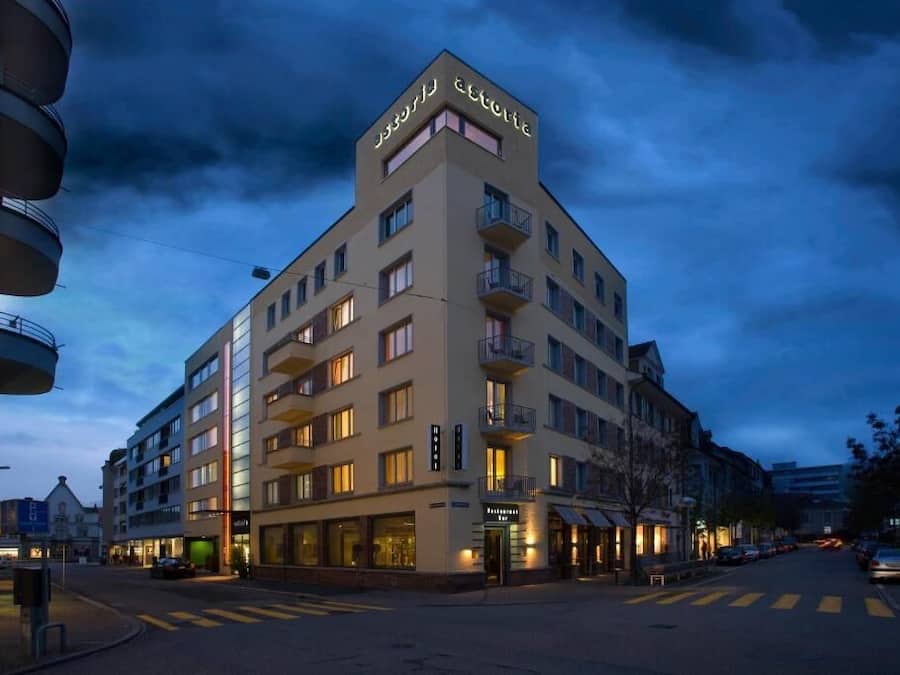 A multi-story hotel with balconies, a restaurant, and a visible entrance.