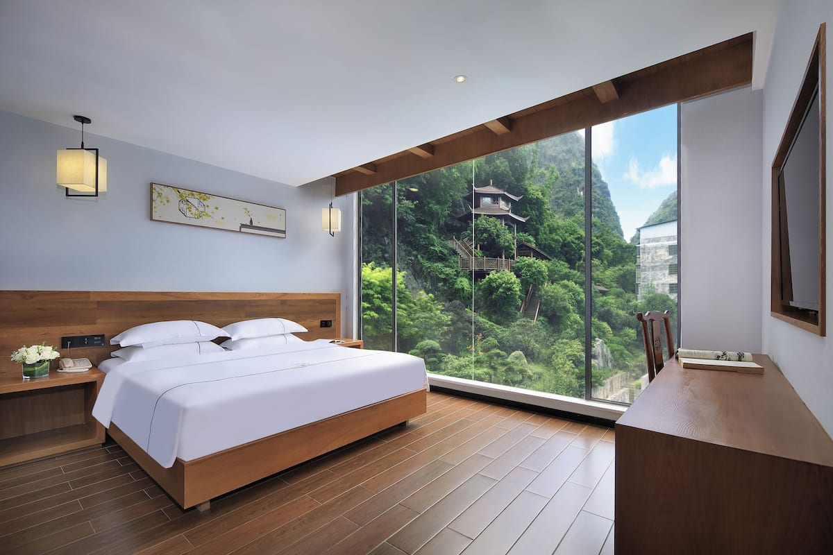 Luxury Suite, 1 Queen Bed, Refrigerator, Hill View | Desk, laptop workspace, blackout drapes, free WiFi