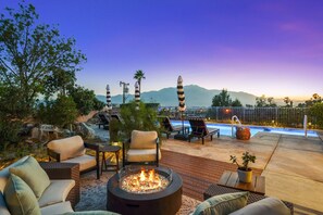 A rooftop patio with outdoor seating, a fire pit, and a swimming pool. - Casa Solara: Panoramic Views, Pool & Spa, GameRoom (Desert Hot Springs)