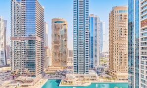 A high-rise building with multiple floors, large windows, and a prominent sign. - bnbme - Lakeside Residence - 1BR (Dubai)