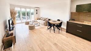 A modern living space with a dining area, sofa, and kitchen. - Sea view - Large terrace - Walking distance to beaches - Air conditioning - Parking (Bandol)