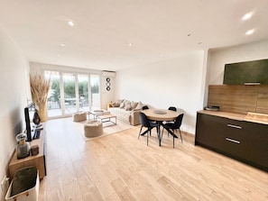 A modern living space with a dining area, sofa, and kitchen. - Sea view - Large terrace - Walking distance to beaches - Air conditioning - Parking (Bandol)