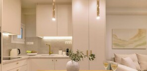 A modern kitchen with a sink, countertop, and a vase with greenery. - Chic Stay | Spa-Style Bath | Acropolis (Athens)