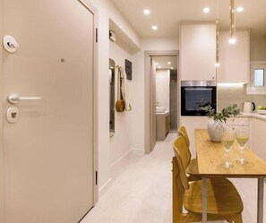 A modern kitchen with a dining area, a refrigerator, and a sink. - Chic Stay | Spa-Style Bath | Acropolis (Athens)