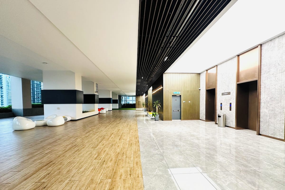 A spacious lobby with a wooden floor, a reception desk, and a door marked 'Lobby 3'.