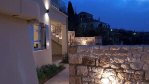 A modern building with a stone wall and a balcony. - Ostria Studio, Kyparissia OldTown Home Collection (Kiparissia)