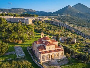 An ancient fortified structure with a central building featuring domed roofs and arched walkways. - Charming Country House, Just Steps from Everything (Kiparissia)