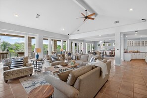 A spacious living area with a large sofa, a coffee table, and a dining area. - Bay Point Oasis  | Concierge Services (Horseshoe Bay)