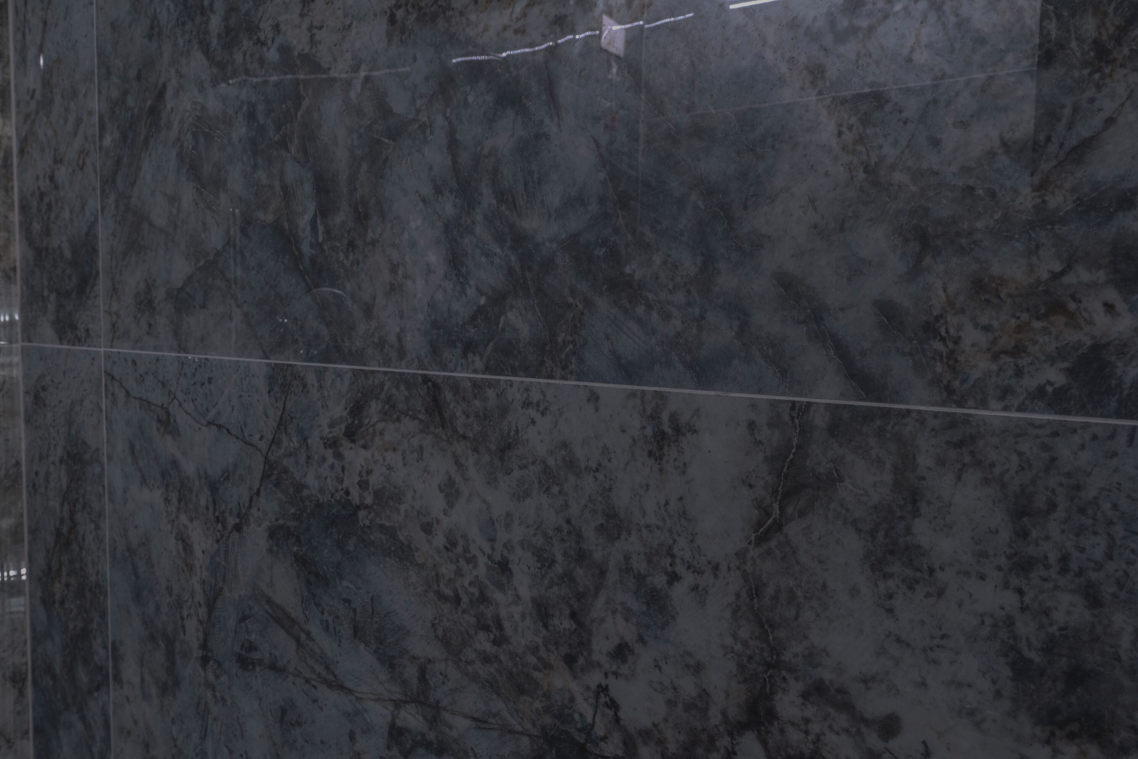A marble wall with a visible crack and a horizontal line.