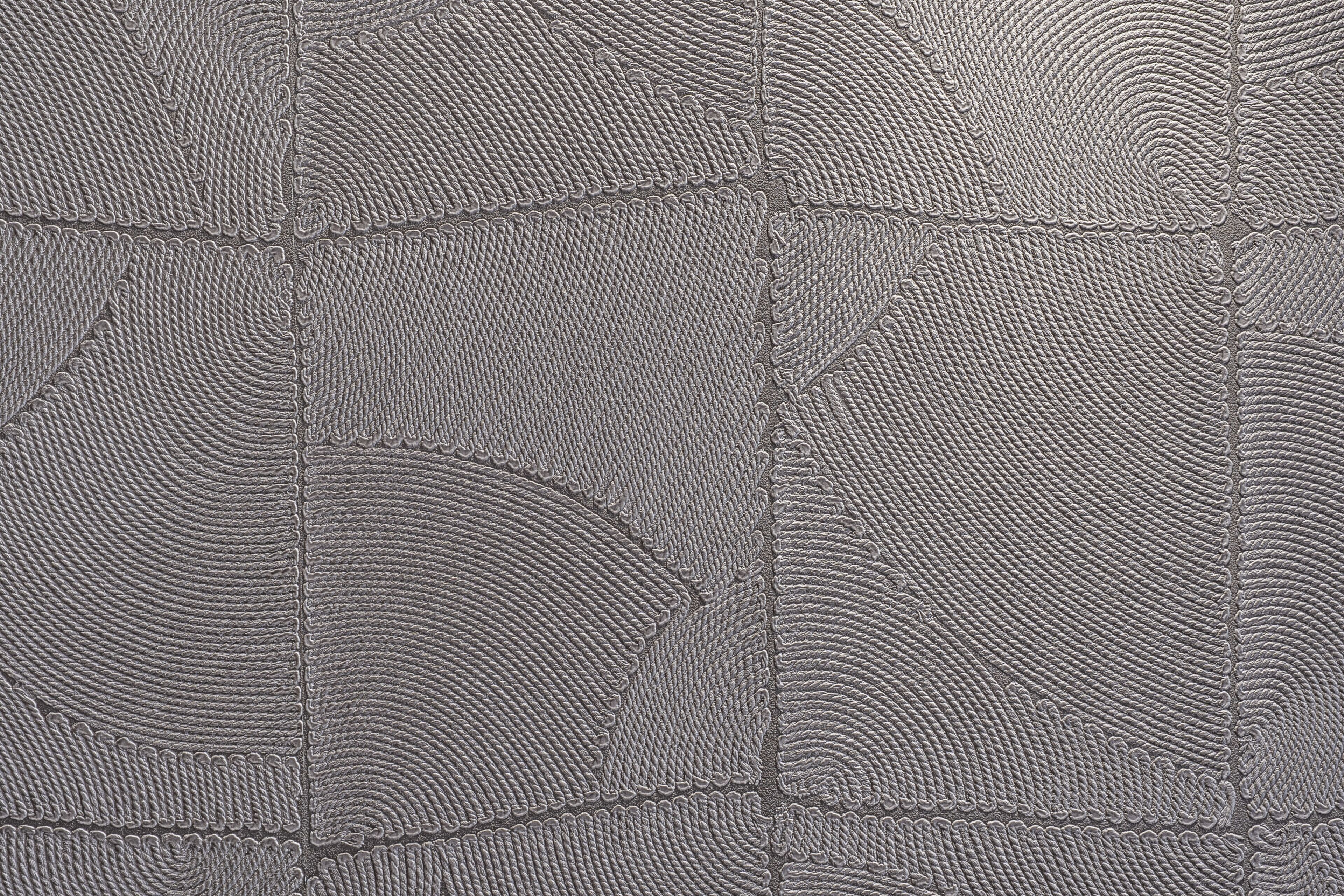 A close-up of a textured surface with a pattern resembling interlocking shapes.