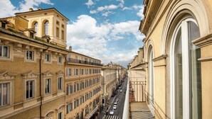 A street view of a building with classical architecture, featuring arched windows and balconies. - Signature Rooms by Hannah Hotels Collection (Rome)