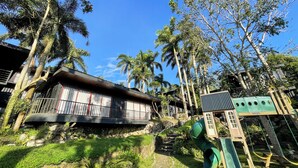 A house with a stone staircase, a wooden deck, and a swing set. - Tagaytay Haven Ulat Managed by Novella (Tagaytay)