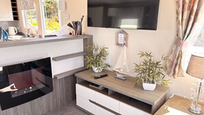 A modern kitchen with a built-in microwave, a coffee maker, and a small sink. - Seaside Escape in Wemyss Bay (Wemyss Bay)