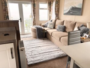 A cozy living area with a sofa, a small table, and a radiator.