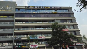 A multi-story building with signs for 'Hotel Belva,' 'Hotel White Palace,' and 'A.C. Rooms.' - HOTEL BELVA (Ahmedabad)
