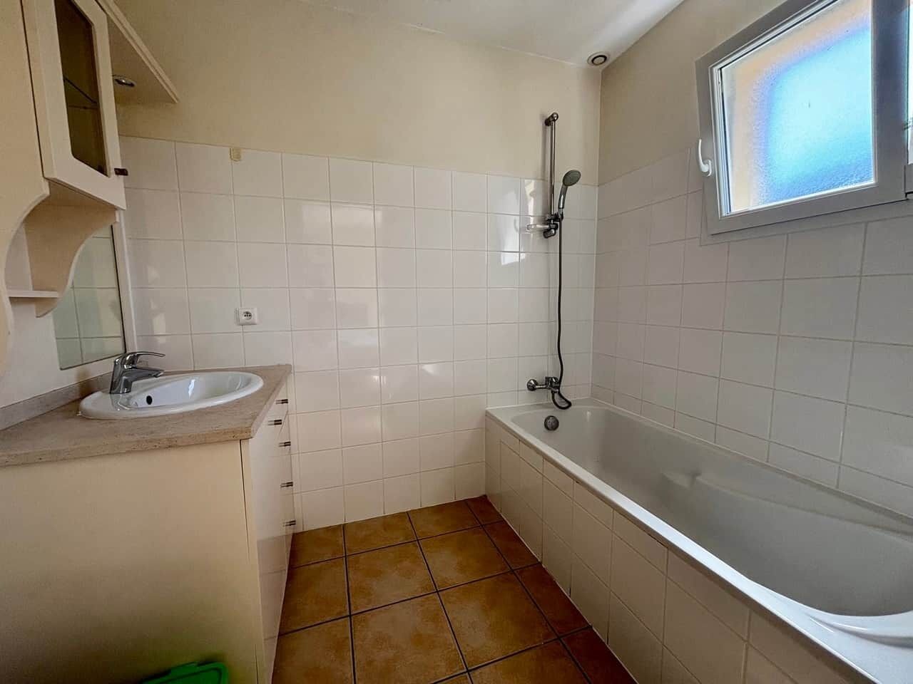 A bathroom with a sink, bathtub, and shower.