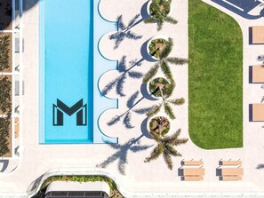 A rooftop with a pool, palm trees, and lounge chairs. - Lvl 50 Skyhome 3BR-Ocean Views, 2 Pools, Parking (Surfers Paradise)