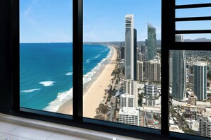 Take in breathtaking high-altitude panoramas of the coastline and golden sandy beaches through large glass windows - Lvl 50 Skyhome 3BR-Ocean Views, 2 Pools, Parking (Surfers Paradise)