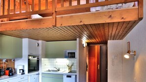 A compact kitchen with white cabinets, a microwave, and a sink. - Studio with mezzanine near village center - 4 guests (Le Grand-Bornand)