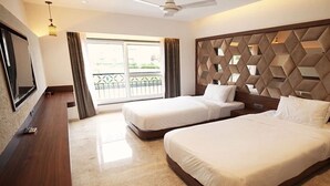 A hotel room with two beds, a TV, a balcony with a view, and a modern headboard. - Estrella The Resort (Karjat)