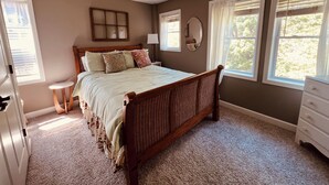 A bedroom with a wooden bed, a nightstand, a dresser, and a window with blinds. - Dragonfly Inn II 
Fabulous 2BR 1BA modern downtown apt  walk to everything (Winchester)