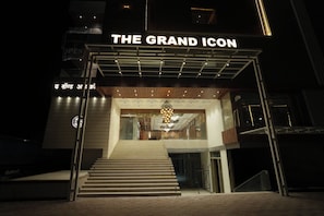 A hotel entrance with a grand icon sign, a staircase leading to the lobby, and a modern interior design. - The Grand Icon (Chandrapur)