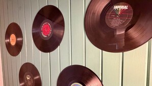 A wall with vinyl records arranged in a pattern. - The Vinyl Lounge at The Cedar (Sandusky)