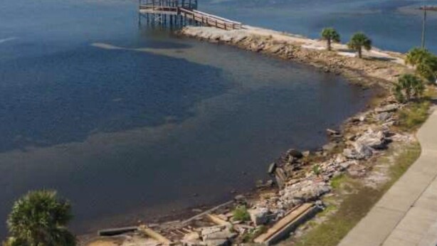 A pier extending into a body of water with a small structure at the end. - Joe's Place- A Hidden Gem by the Bay (Port St Joe)