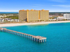 A coastal hotel with a pier extending into the sea, surrounded by other buildings. - High Floor 1 bedroom with Gulf Views Plus Bunk Bed (Panama City Beach)