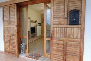 A wooden door with a glass panel, a mailbox, and a welcome mat. - Poggio delle Ginestre Vacation Home in Torre a Mare, Bari—Pool, Parking, Sleeps 4 (Parco Scizzo-parchitello)
