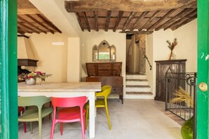 A dining area with a wooden table, chairs, and a mirror above it.