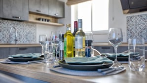 A kitchen counter with wine bottles, glasses, and plates. - Luxury duplex apartment, sun terrace, jacuzzi SDIN1-1 (Swieqi)