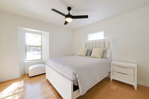 A bedroom with a bed, nightstand, and ceiling fan. - Pet-friendly Phoenix Retreat: Main House + Casita! (Phoenix)