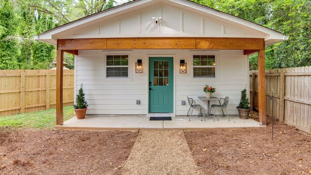 A small house with a porch, a green door, and two windows with exterior lighting. - Couples Retreat! 7 Mi to Dtwn Atlanta & Six Flags (Atlanta)