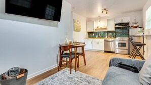 A modern kitchen with white cabinets, a microwave, and a dishwasher. - Couples Retreat! 7 Mi to Dtwn Atlanta & Six Flags (Atlanta)