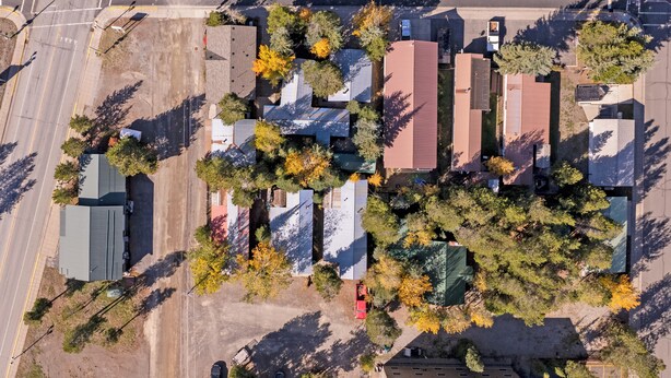 An aerial view of a residential area with houses, trees, and a road. - 'fox Cabin' - 6 Blocks to Yellowstone Nat'l Park! (West Yellowstone)