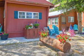 A red building with a porch, potted plants, and outdoor seating. - 6 Blocks to Yellowstone NP: 'bison Home' w/ BBQ (West Yellowstone)