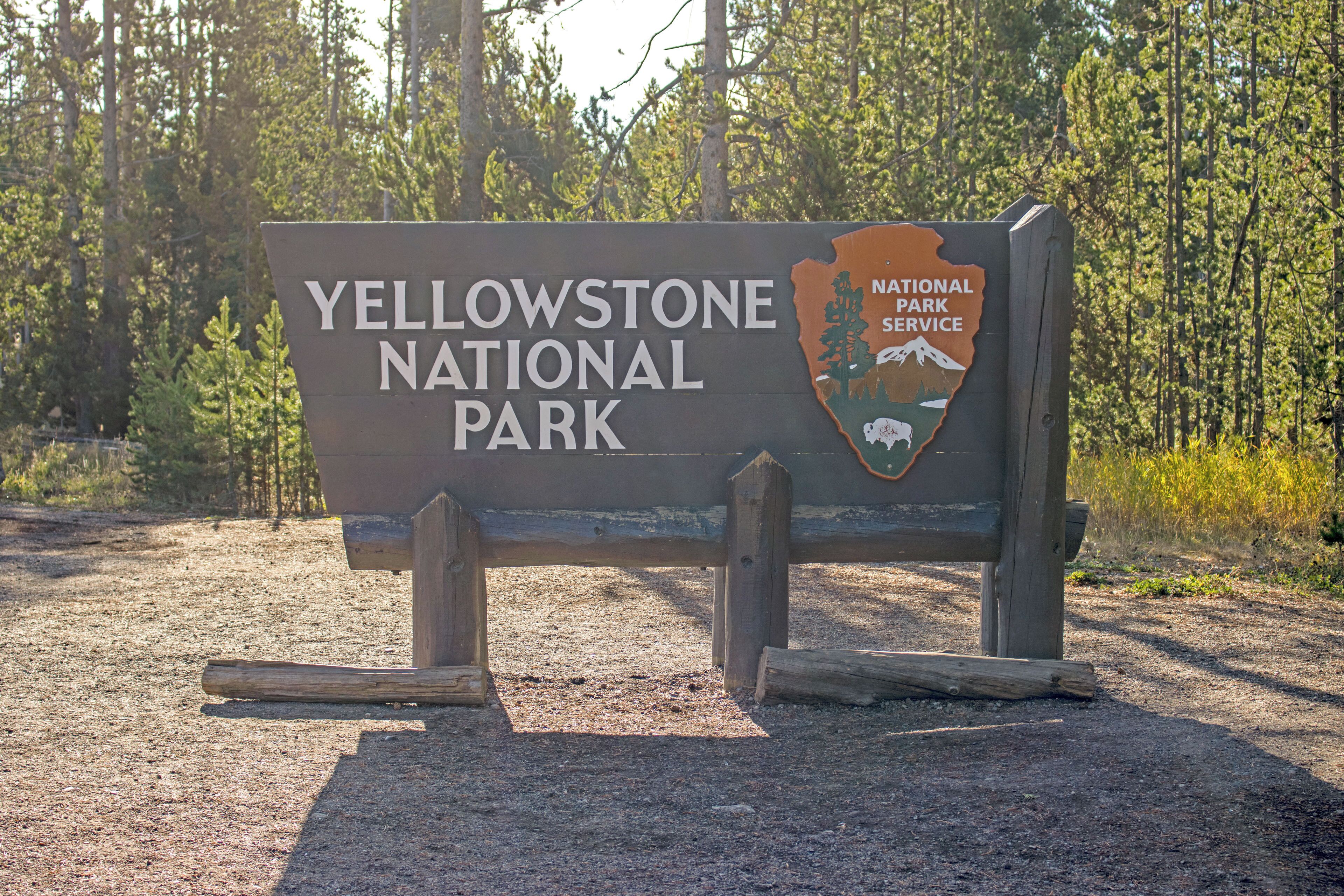 A sign for Yellowstone National Park with a logo and text.
