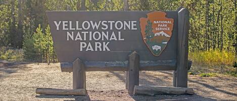 A sign for Yellowstone National Park with a logo and text.