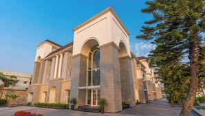 A building with a symmetrical facade, large windows, and a central entrance with steps. - Ranveer the Garden Resort (Haldwani)