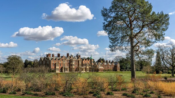 A large, historic building with multiple towers and a well-maintained lawn in front. - Old Church Hall, Glandford, Norfolk (Glandford)